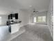 Open living room with carpet flooring and access to the kitchen at 4376 Sagefield Dr, Harmony, FL 34773