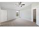 Neutral bedroom with new carpet, vaulted ceilings, a ceiling fan, and natural light at 7856 Habersham Dr, Lakeland, FL 33810