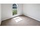Neutral bedroom with new carpet, natural light, and fresh white trim at 7856 Habersham Dr, Lakeland, FL 33810