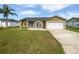 Charming single-story home with a well-manicured lawn and a two-car garage at 7856 Habersham Dr, Lakeland, FL 33810