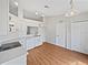 Bright kitchen features white cabinets, appliances, and countertops, with light, wood-look floors at 7856 Habersham Dr, Lakeland, FL 33810