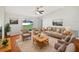 Bright living room featuring neutral furniture and hardwood floors at 7856 Habersham Dr, Lakeland, FL 33810