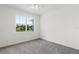 Bright bedroom featuring neutral gray carpet and a large window letting in natural light at 9313 Quiet Ln, Winter Garden, FL 34787