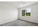 Bright bedroom featuring neutral gray carpet and a large window letting in natural light at 9313 Quiet Ln, Winter Garden, FL 34787