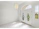 Elegant entryway featuring double doors with decorative glass and a modern chandelier at 9313 Quiet Ln, Winter Garden, FL 34787
