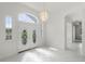 Bright entryway featuring white tile floors, double doors, and a chandelier at 9313 Quiet Ln, Winter Garden, FL 34787
