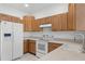 Well-maintained kitchen with wooden cabinetry and white appliances at 9313 Quiet Ln, Winter Garden, FL 34787