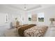 Cozy main bedroom featuring a neutral color scheme, tray ceiling, and ample natural light at 9313 Quiet Ln, Winter Garden, FL 34787