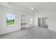 Spacious main bedroom with large windows, built-in shelving, and plush carpet at 9313 Quiet Ln, Winter Garden, FL 34787