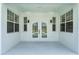Outdoor covered patio area with double doors that reflect the community swimming pool at 9313 Quiet Ln, Winter Garden, FL 34787