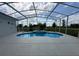 Enclosed screened-in pool and integrated spa features a light-colored concrete surround and open yard at 9313 Quiet Ln, Winter Garden, FL 34787