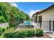 Private, fenced backyard with a luxurious pool and spa offers an idyllic retreat for relaxation and entertainment at 10193 Brocksport Cir, Gotha, FL 34734