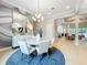 Elegant dining room with a round table, statement mirror, and stylish chandelier at 10193 Brocksport Cir, Gotha, FL 34734
