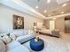 Spacious main bedroom with a sitting area, tray ceiling, and ensuite bathroom at 10193 Brocksport Cir, Gotha, FL 34734