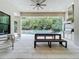 Inviting outdoor kitchen and patio area with barbecue, wood table and bench overlooking the pool at 10193 Brocksport Cir, Gotha, FL 34734