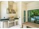 Outdoor kitchen equipped with stainless steel grill, a mini fridge, granite countertops and storage space at 10193 Brocksport Cir, Gotha, FL 34734