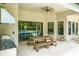 Covered outdoor living area with full kitchen, wood-burning pizza oven, and view of the refreshing pool at 10193 Brocksport Cir, Gotha, FL 34734