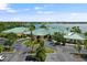 Aerial view of a yellow clubhouse with a lake in the background and ample parking at 2877 Attwater Loop, Winter Haven, FL 33884