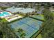 Overhead shot of the community clubhouse, pool, tennis courts, basketball court, and parking at 2877 Attwater Loop, Winter Haven, FL 33884