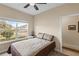 Comfortable bedroom with a cozy bed, window, and view of the neighborhood at 2877 Attwater Loop, Winter Haven, FL 33884