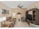Comfortable living room with a sofa, TV, ceiling fan, and modern décor at 2877 Attwater Loop, Winter Haven, FL 33884