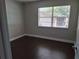 Bedroom with hardwood floors, a window with blinds, and neutral paint at 1181 Paseo Del Mar # D, Casselberry, FL 32707