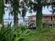 Exterior view of a waterfront home with a private dock and lush greenery at 1181 Paseo Del Mar # D, Casselberry, FL 32707
