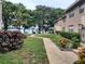 Beautiful condo exterior featuring manicured landscaping and a serene pathway leading to the lake at 1181 Paseo Del Mar # D, Casselberry, FL 32707