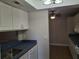 Clean kitchen with white cabinets, appliances and tile floor at 1181 Paseo Del Mar # D, Casselberry, FL 32707