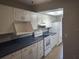 Well-lit kitchen showcases white appliances, ample counter space and cabinetry at 1181 Paseo Del Mar # D, Casselberry, FL 32707