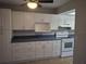 Bright kitchen featuring white cabinets and appliances, and complementary countertops at 1181 Paseo Del Mar # D, Casselberry, FL 32707
