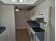 Airy kitchen with white cabinets, modern appliances and a ceiling fan at 1181 Paseo Del Mar # D, Casselberry, FL 32707