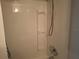Bright white shower with convenient built-in shelving and adjustable shower head fixture at 1181 Paseo Del Mar # D, Casselberry, FL 32707