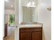 Bathroom featuring a vanity with a white sink and storage, adjacent to the living area at 4032 Mountain Chestnut Way, Lakeland, FL 33812