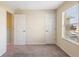 This bedroom has neutral walls, carpet, and a window at 4032 Mountain Chestnut Way, Lakeland, FL 33812