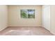 This bedroom has neutral walls, carpet, and a window at 4032 Mountain Chestnut Way, Lakeland, FL 33812