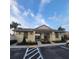 A charming one-story community building with accessible entrance, beige tones and decorative shutters at 4032 Mountain Chestnut Way, Lakeland, FL 33812