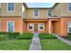 Charming townhome featuring a well-maintained lawn and inviting front entrance at 4032 Mountain Chestnut Way, Lakeland, FL 33812