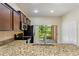 A kitchen featuring granite countertops and a stainless steel microwave with view of the backyard at 4032 Mountain Chestnut Way, Lakeland, FL 33812