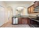 The kitchen showcases granite countertops and stainless steel appliances with a view to living area at 4032 Mountain Chestnut Way, Lakeland, FL 33812