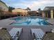 Relaxing community pool with ample lounge chairs and a calming view at 4032 Mountain Chestnut Way, Lakeland, FL 33812