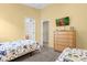 ' bedroom with twin beds, dresser, and a TV, plus access to the bathroom at 313 Kensington Dr, Davenport, FL 33897