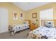Well-lit bedroom with twin beds, construction-themed bedding, and a dresser at 313 Kensington Dr, Davenport, FL 33897