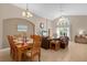 Combined dining and living room with hardwood table and comfortable seating at 313 Kensington Dr, Davenport, FL 33897