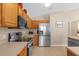 Modern kitchen with stainless steel appliances and wood cabinetry at 313 Kensington Dr, Davenport, FL 33897