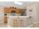 Kitchen boasts wood cabinets, stainless steel appliances, and a breakfast bar at 313 Kensington Dr, Davenport, FL 33897