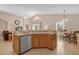 Open kitchen with an island, stainless steel appliances, and wood cabinets at 313 Kensington Dr, Davenport, FL 33897