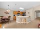 Kitchen with wood cabinets, stainless steel appliances, and an island with seating at 313 Kensington Dr, Davenport, FL 33897