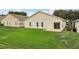 Spacious backyard with lush lawn and access to the house through a sliding glass door at 475 Windsor Pl, Davenport, FL 33896