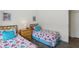 Comfortable bedroom with twin beds, wood furnishings, and soft decor at 475 Windsor Pl, Davenport, FL 33896